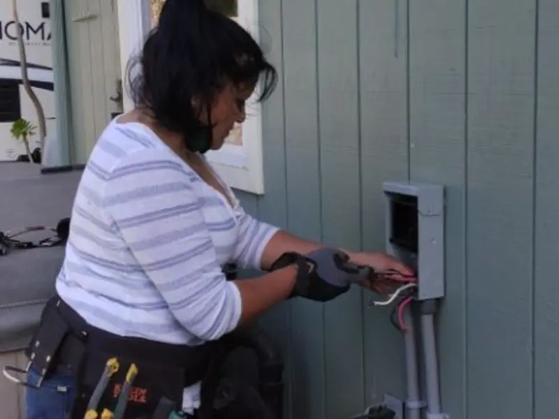 Licensed electrician wiring an exterior subpanel in Warren